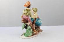 Load image into Gallery viewer, Capodimonte Porcelain Figurine – Boy and Girl Playing See-Saw on Log