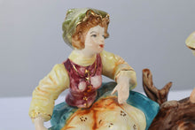 Load image into Gallery viewer, Capodimonte Porcelain Figurine – Boy and Girl Playing See-Saw on Log