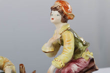Load image into Gallery viewer, Capodimonte Porcelain Figurine – Boy and Girl Playing See-Saw on Log
