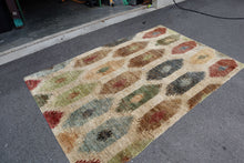 Load image into Gallery viewer, Handwoven Jute Rug – 64” x 100” – Multi-Color Tribal Motif