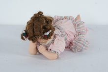 Load image into Gallery viewer, Vintage Porcelain Girl Doll – Lying Pose with Curly Hair, Pink Dress &amp; Floral Hair Bows
