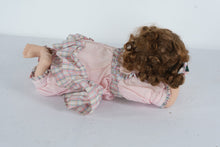 Load image into Gallery viewer, Vintage Porcelain Girl Doll – Lying Pose with Curly Hair, Pink Dress &amp; Floral Hair Bows
