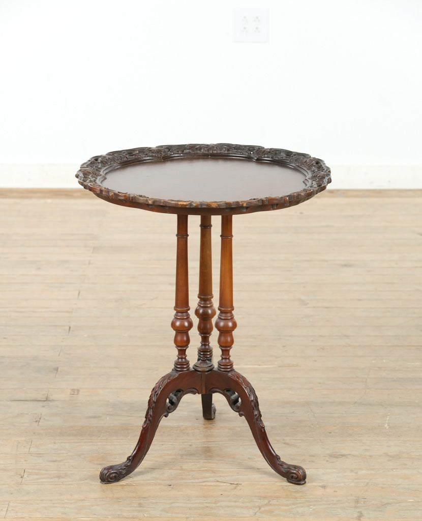 The Acanthus Crest Pie Crust Table – Triple Pedestal Mahogany Accent