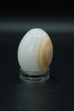 Load image into Gallery viewer, Polished Onyx Stone Egg with Stand – Natural Cream &amp; Amber Tones
