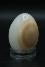 Load image into Gallery viewer, Polished Onyx Stone Egg with Stand – Natural Cream &amp; Amber Tones
