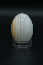 Load image into Gallery viewer, Polished Onyx Stone Egg with Stand – Natural Cream &amp; Amber Tones
