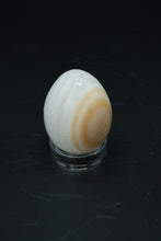 Load image into Gallery viewer, Polished Onyx Stone Egg with Stand – Natural Cream &amp; Amber Tones

