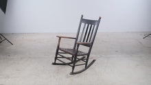 Load and play video in Gallery viewer, Antique Style Black Wood Rocking Chair Woven Seat Ladder Back 39 Inch
