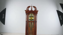 Load and play video in Gallery viewer, Howard Miller Traditional Cherry Grandfather Clock with Moon Phase Dial and Cable Driven Movement
