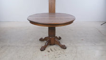 Load and play video in Gallery viewer, Traditional Oak Round Pedestal Dining Table with Claw Feet and 12-Inch Extension Leaf
