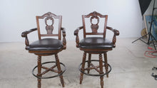 Load and play video in Gallery viewer, Ashley North Shore D553 130 Swivel Bar Stools Set of 2 Carved Wood 30 Inch
