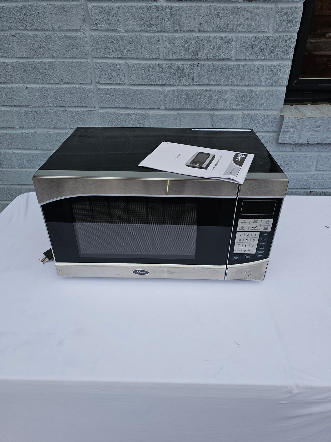 Oster 0.9 Cu. Ft. Countertop Microwave – Model OGHS9001, Stainless Steel Finish